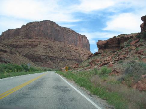 Desert Varnish & talus slope highlight this Sandstone bluff carved by the Colorado River east of Moab, Utah