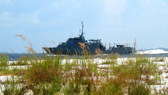 Navy mine sweeper passing by St Andrews State Park