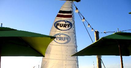 Sail on one of Fury's fleet of boats as it passes Sunset Pier