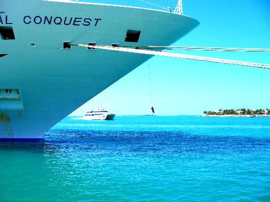 Sunset Island in the distance with the Key West Express and cruise ship Carnival Conquest