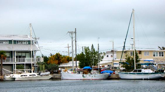 Liveaboard boats tied up behind apartmant and condominium buildings on Stock Island