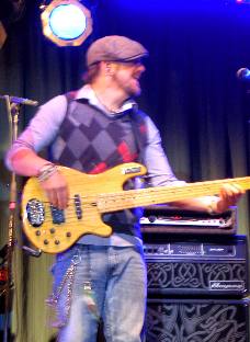 Neal McCoy's bass player performing on the outdoor stage at Outlaw Saloon