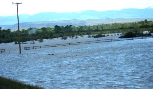 The Wind River is flooding pasture lands southeast of Bull Lake on US-26
