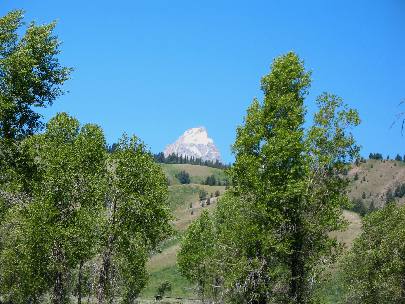Grand Teton Mountain peaking over Black Buck Butte as viewed from the Gros Ventre Campground on Gros Ventre Road in Grand Teton National Park