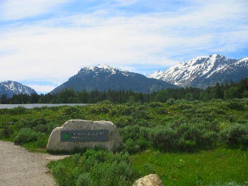 Grand Tetons and a sign welcoming us to Rockerfeller Preserve in Grand Teton National Park