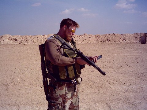Chuck "Big Daddy" Meier with a gun found in an ammo cache deep in the Sand Box