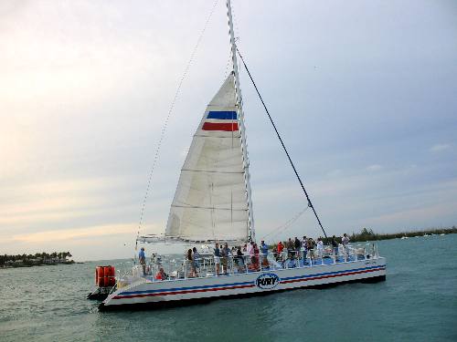 A Fury Catamaran sailing past Sunset Pier on their nightly sunset cruise 