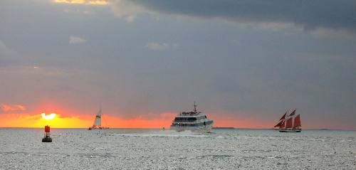 A Fury fleet boat, the Key West Express and the Jolly Rover with the red sails