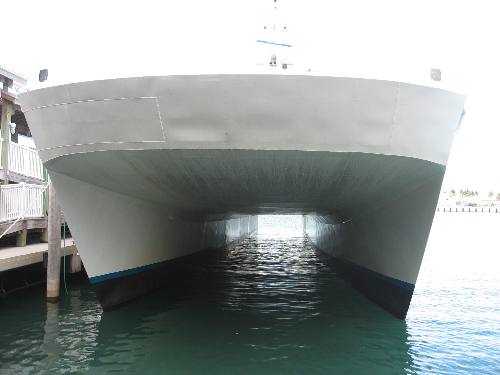 Looking through the huge twin hulls of the Big Cat Express from Harbor Walk in Key West Bight Marina