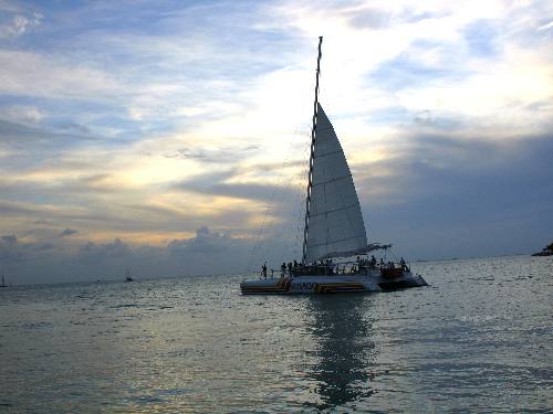 One of the Sebago catamarans sailing into the sunset off Key West
