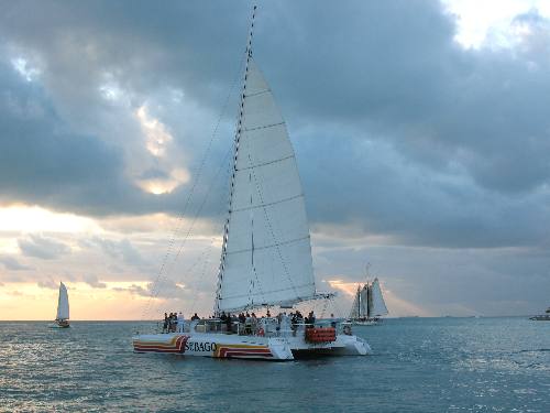 One of the Sebago catamarans with a load of passengers enjoying a sunset cruise