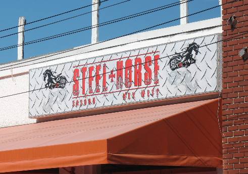 Steel Horse sign visible from the corner of Green & Duval Street in Key West, Florida