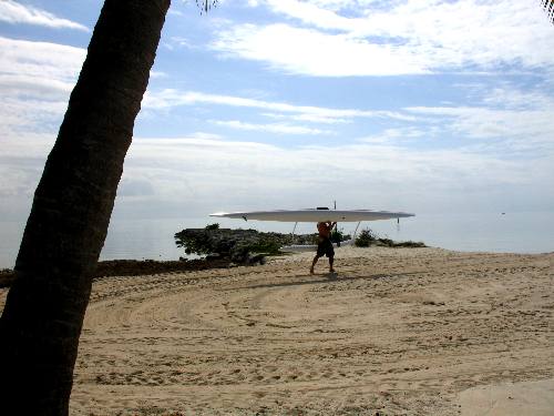 Kayaker transporting his kayak to the water on Smathers Beach