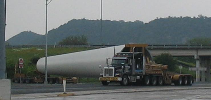 Middle section of wind generator turning off exit ramp in Junction, Texas