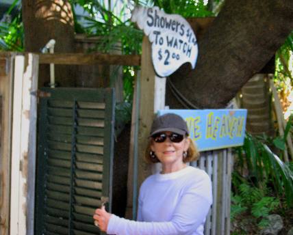 Showers $1.00 To Watch $2.00 sign on outdoor shower at Blue Heaven