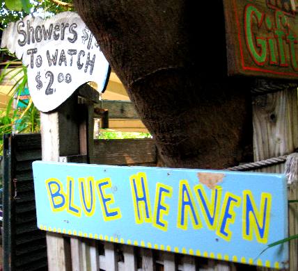 Showers $1.00 To Watch $2.00 sign on outdoor shower at Blue Heaven
